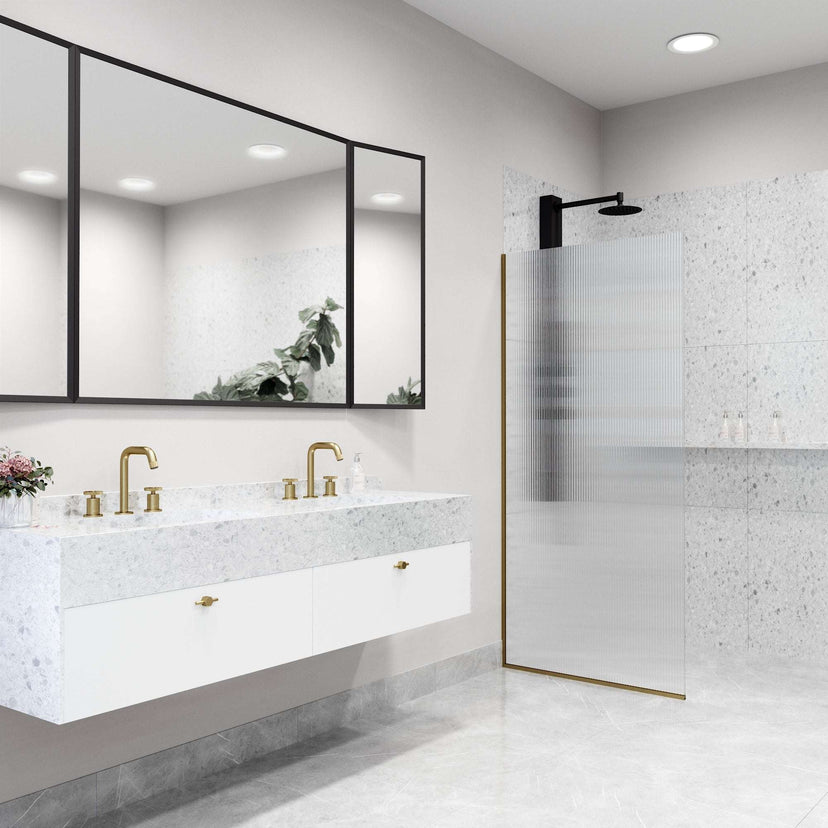Fixed shower screen with matte gold frame, fluted tempered glass, and reversible door