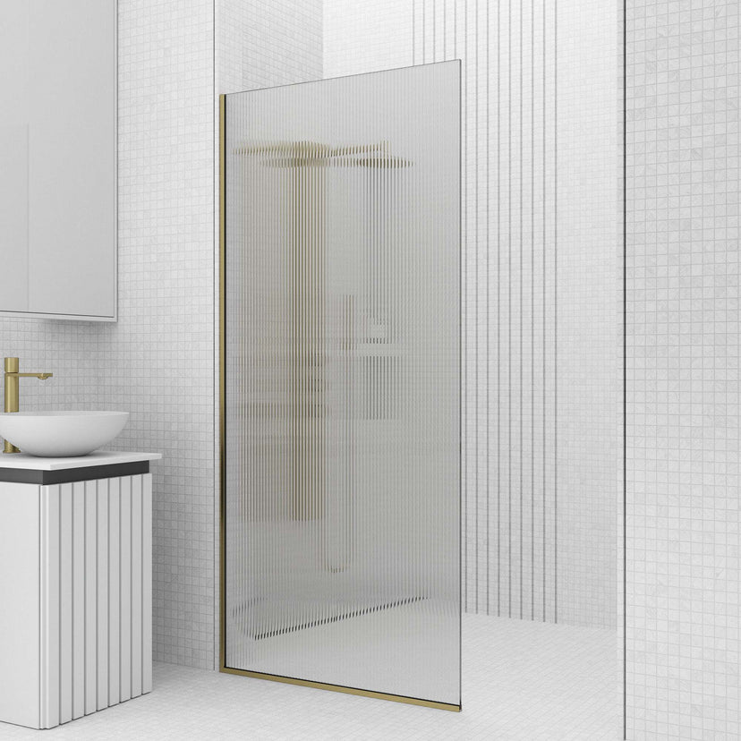 Frameless shower screen with fluted glass, matte gold finish, and fixed installation type