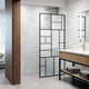 Framed shower screen with matte black grid design and mixed clear, privacy, and white glass panels